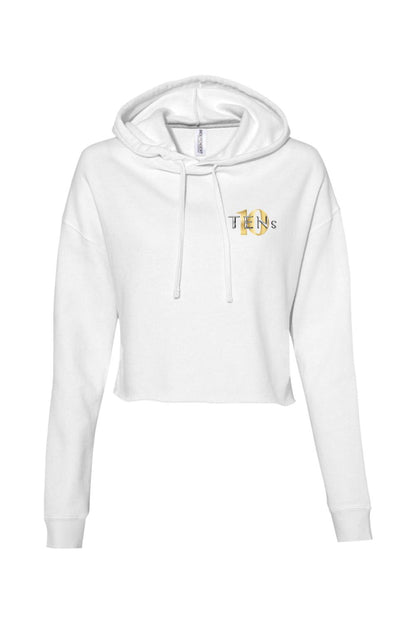 White cropped hooded sweatshirt with long sleeves and a gold and black Tens Show Club logo on the chest.