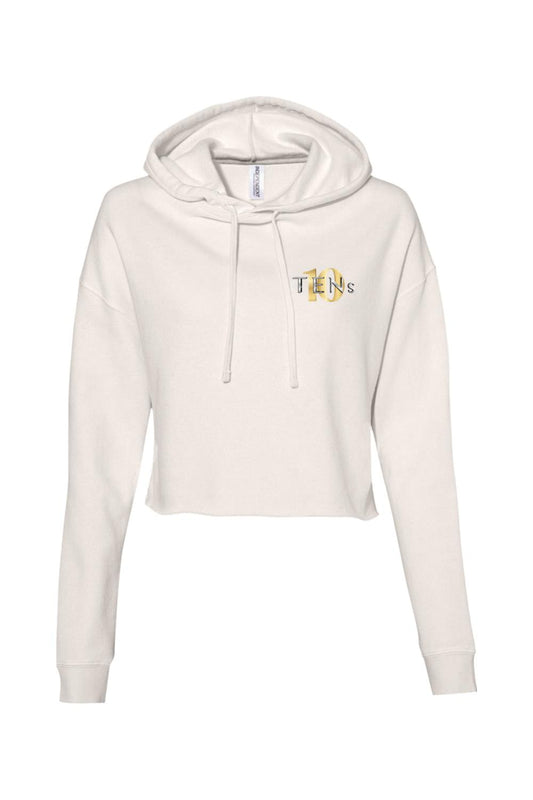 Off-white cropped hooded sweatshirt with long sleeves and a small gold Tens Show Club logo on the chest.