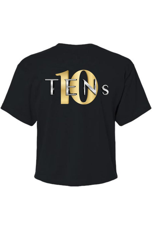 Black cotton cropped tee featuring a metallic gold and silver TENS logo graphic on the front.
