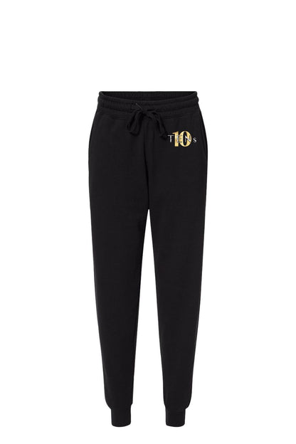 Black cotton sweatpants with an elastic drawstring waist and a gold Tens Show Club logo on the hip.