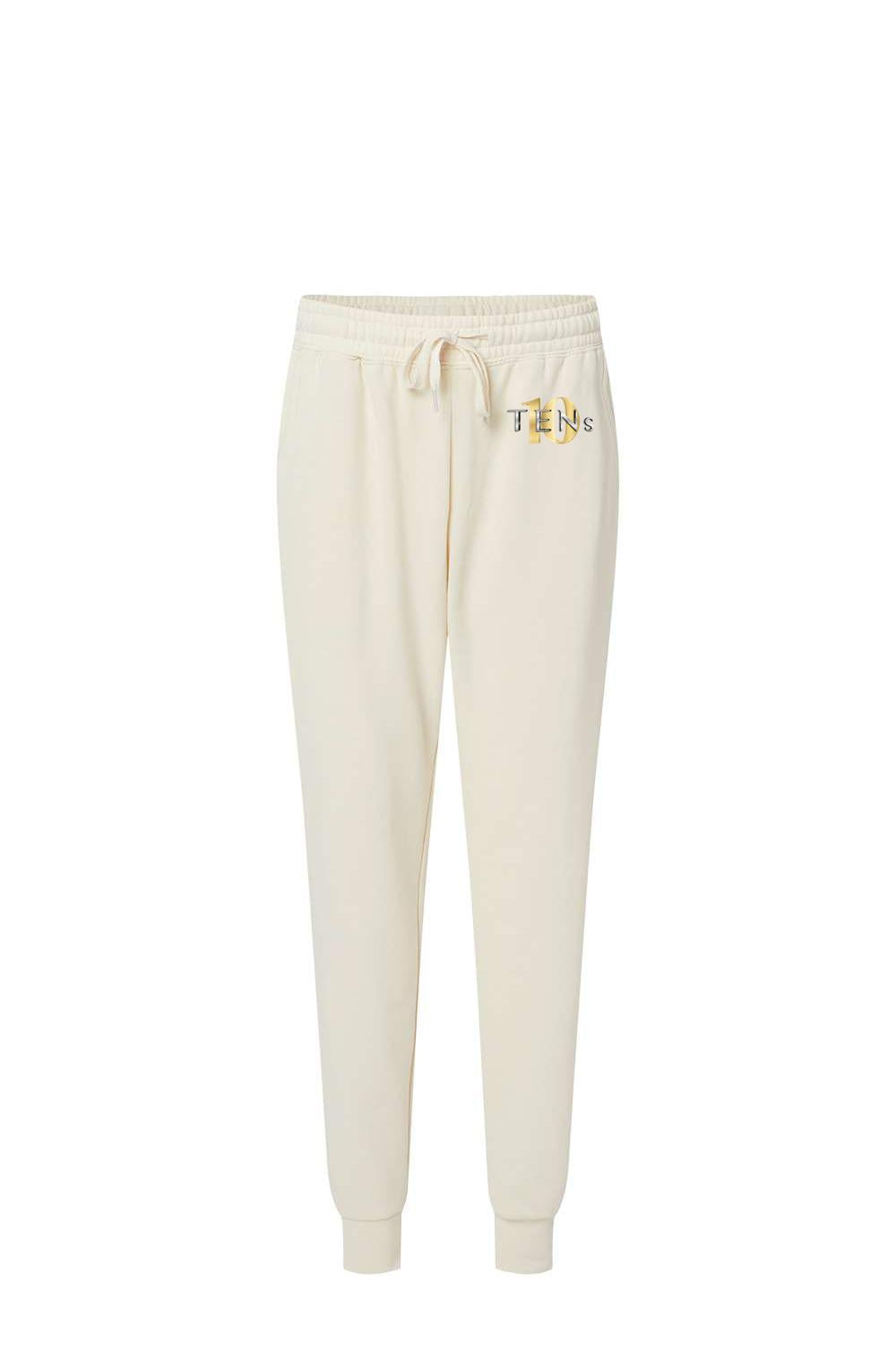 Cream-colored cotton sweatpants with a drawstring waist, ribbed cuffs, and a gold Tens Show Club logo on the hip.