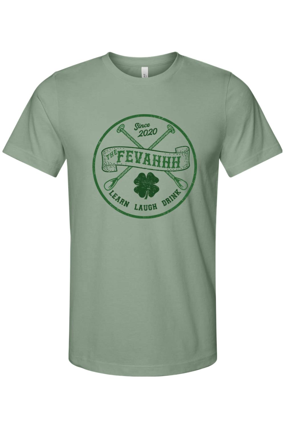 Sage green short-sleeve jersey tee with a circular dark green graphic featuring crossed spoons, a shamrock, and text.
