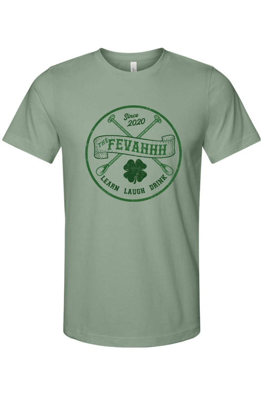Sage green short-sleeve jersey tee with a circular dark green graphic featuring crossed spoons, a shamrock, and text.
