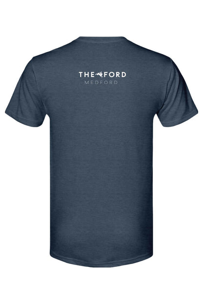Back view of a navy blue triblend t-shirt featuring a white The Ford Medford logo with a small bunny graphic.