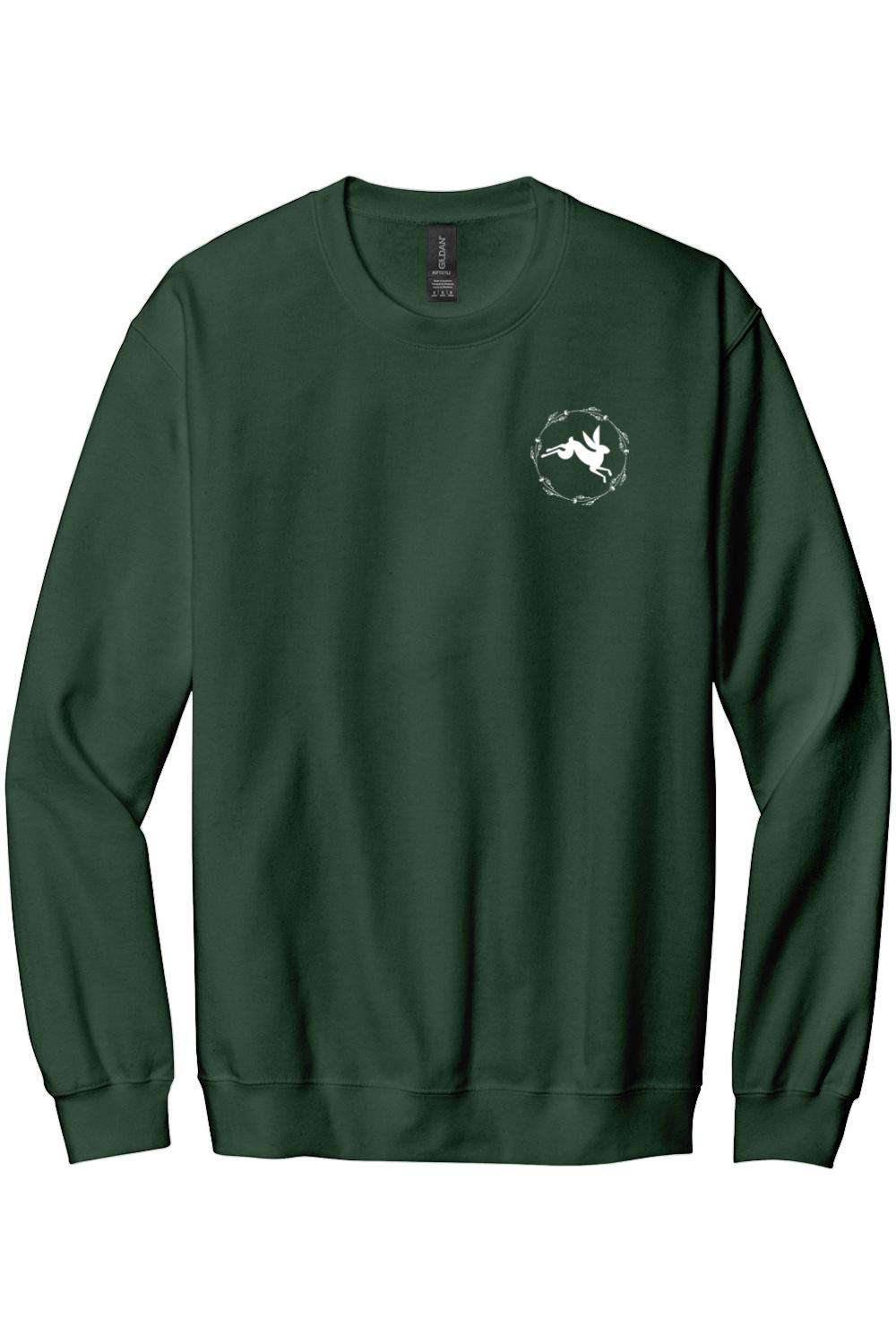 Forest green crewneck sweatshirt featuring a small white rabbit logo inside a circular floral wreath on the chest.