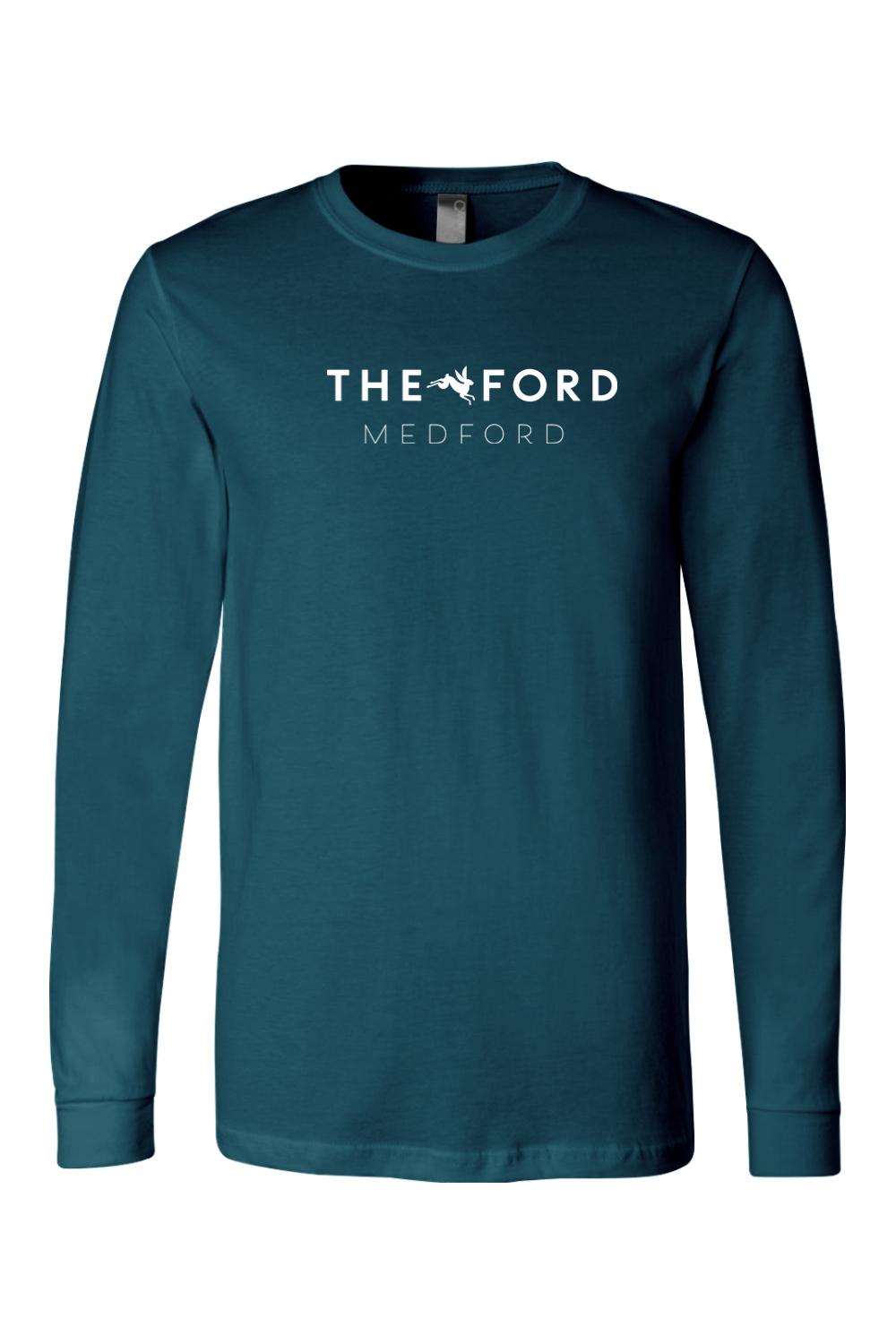 Teal long-sleeve crewneck tee featuring The Ford Medford logo in white on the chest, made from soft cotton.