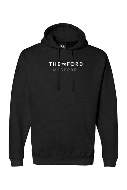 Black premium cotton-blend hoodie featuring The Ford Medford white logo and a kangaroo pocket.