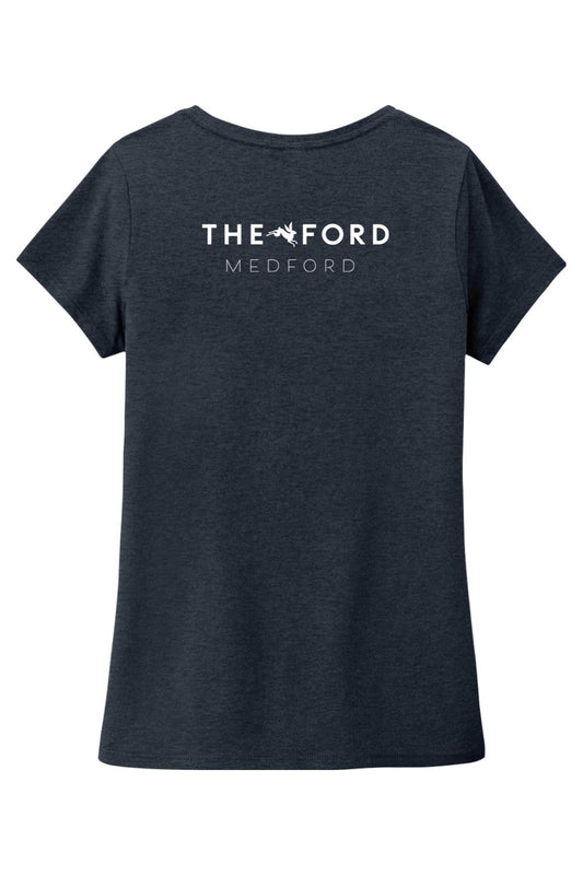 Dark heather grey women’s triblend v-neck tee featuring a white The Ford Medford logo on the back.