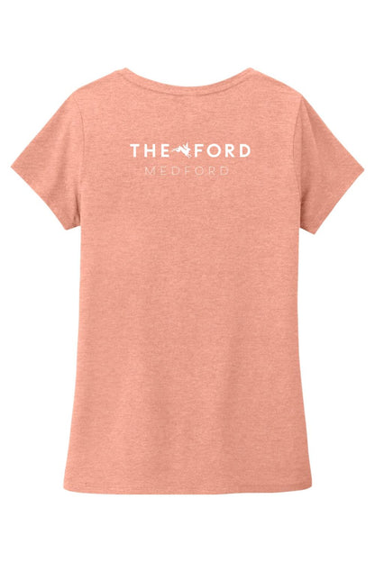Soft peach triblend women's V-neck tee featuring The Ford Medford logo on the back.