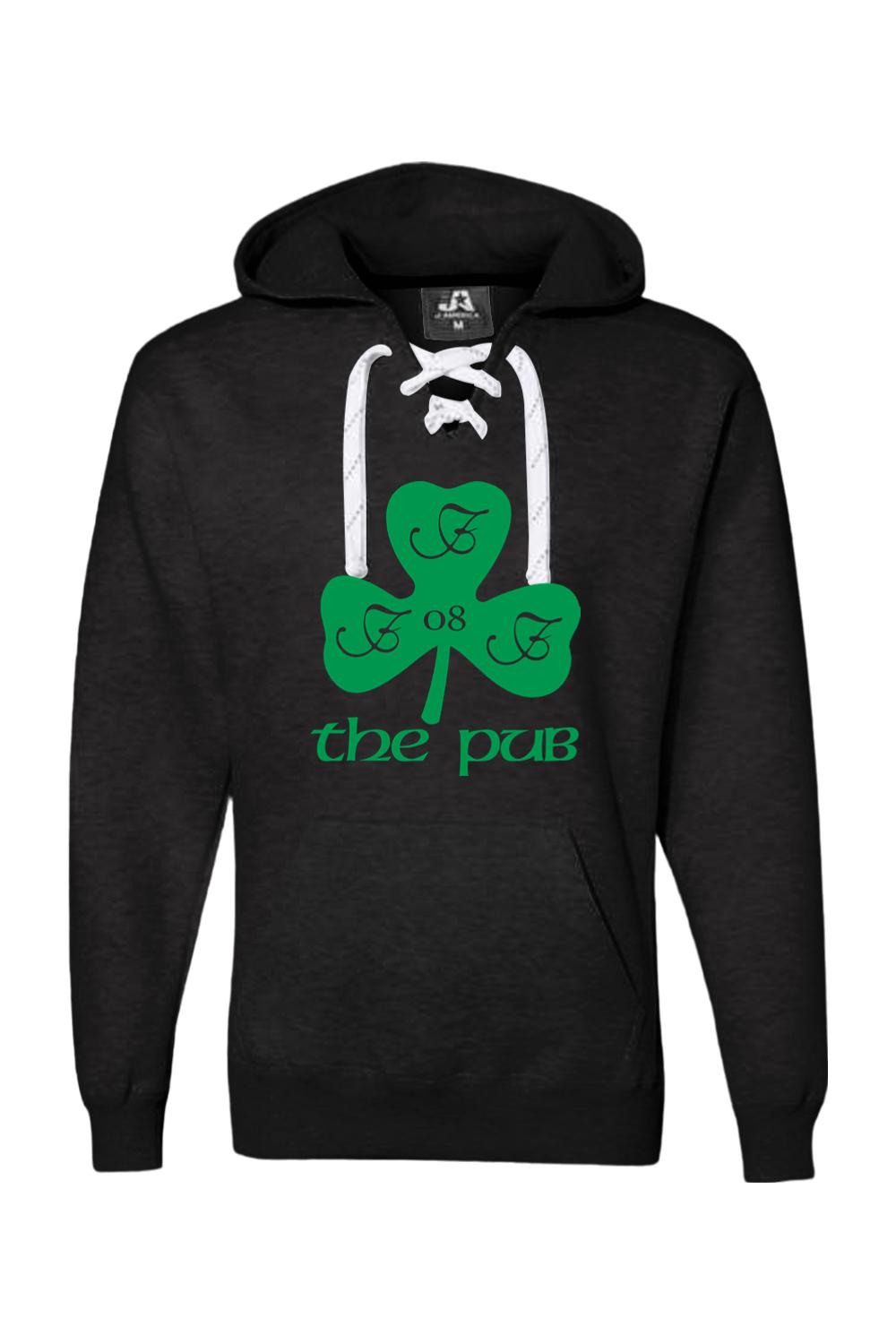 Black hooded sweatshirt with white lace-up neckline, featuring a green shamrock logo and The Pub text graphic.