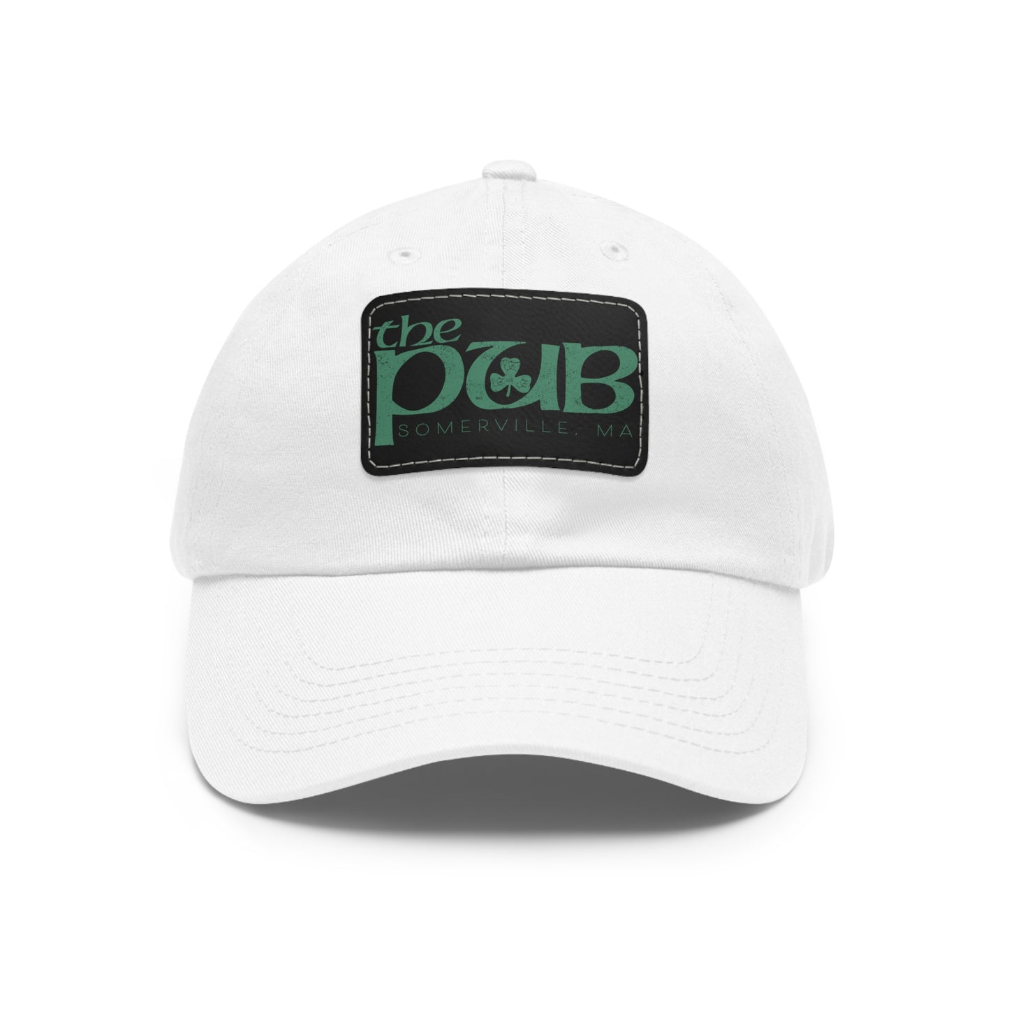 White unstructured dad hat featuring a black faux leather patch with The Pub Somerville green logo.
