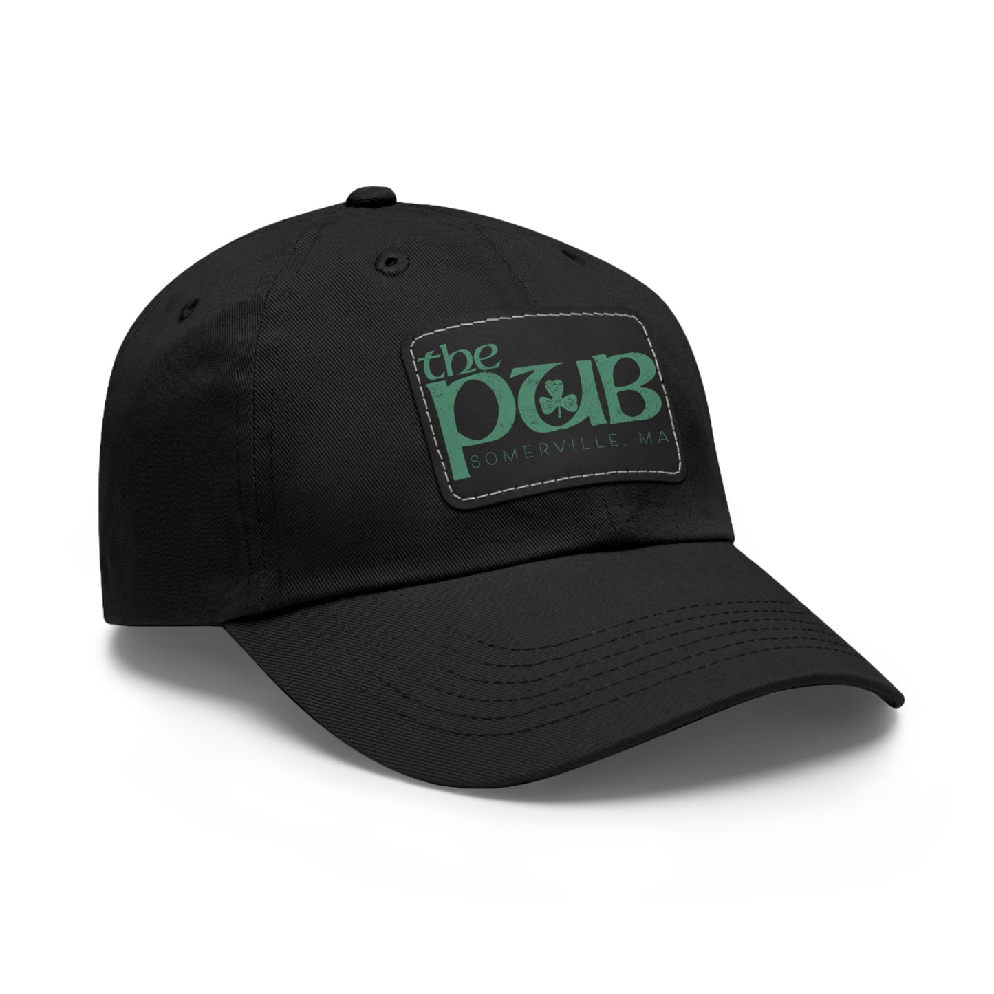 Black unstructured dad hat featuring a faux leather patch with The Pub Somerville green logo and shamrock detail.