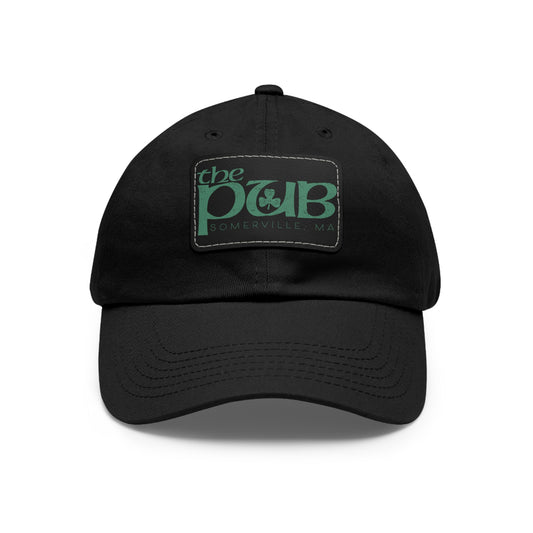 Black unstructured dad hat featuring a faux leather patch with The Pub Somerville logo in green.