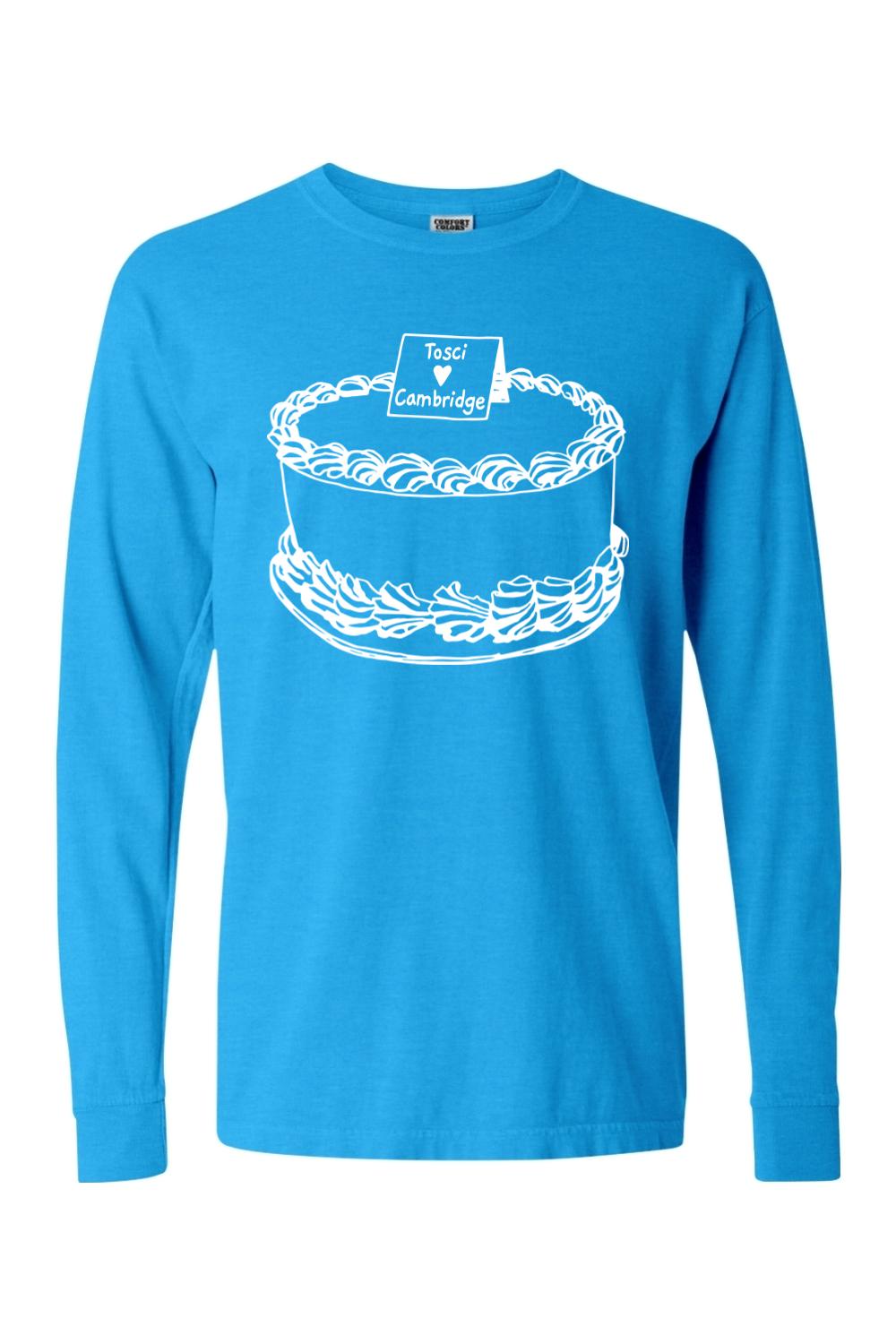 Bright blue Comfort Colors long sleeve tee featuring a white line-art graphic of a cake labeled Tosci Cambridge.
