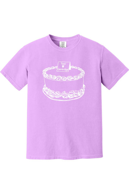 Light purple Comfort Colors short sleeve t-shirt featuring a white line art graphic of a cake with Tosci Cambridge text.