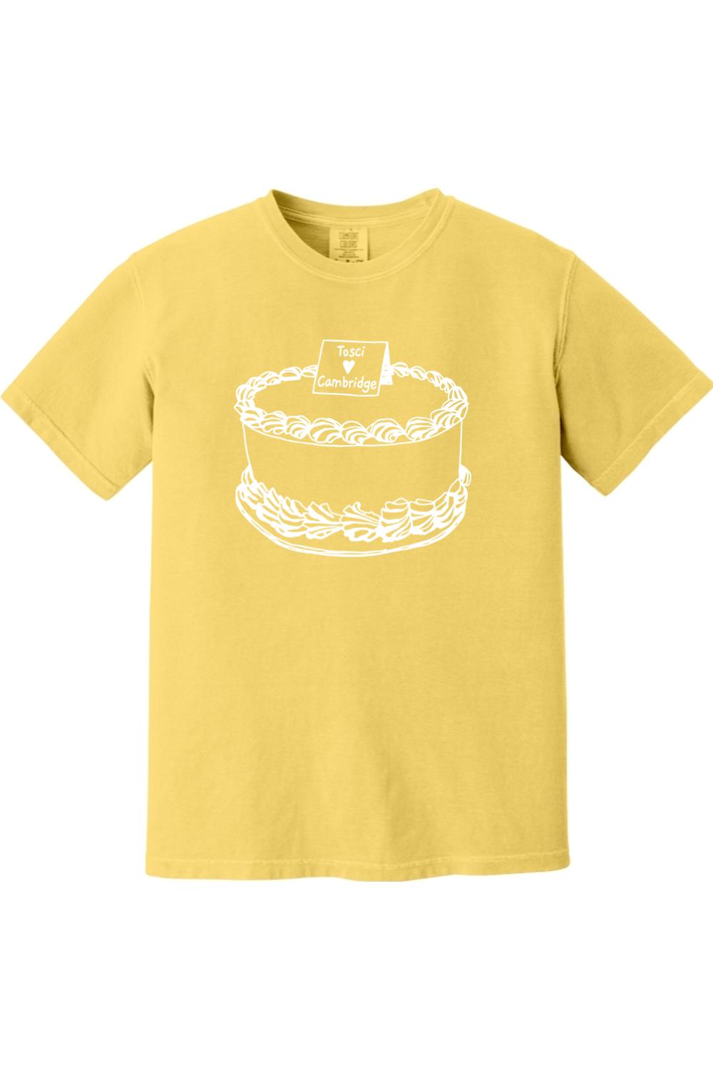 Yellow Comfort Colors short sleeve t-shirt featuring a white line-art graphic of a cake labeled Tosci Loves Cambridge.