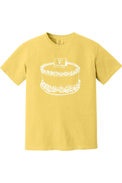 Yellow Comfort Colors short sleeve t-shirt featuring a white line-art graphic of a cake labeled Tosci Loves Cambridge.