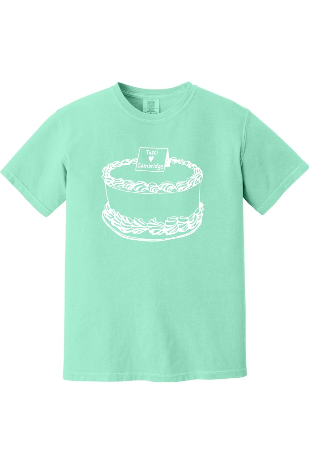 Mint green Comfort Colors short sleeve t-shirt featuring a white line-art graphic of a cake with Tosci Cambridge text.