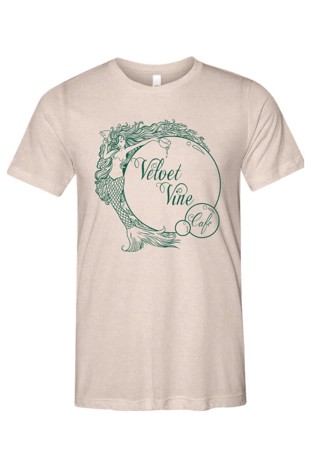 Beige triblend crew neck t-shirt featuring a green Velvet Vine Cafe mermaid logo graphic on the chest.