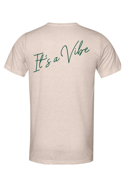 Beige triblend crewneck t-shirt featuring the green script text It's a Vibe on the back.