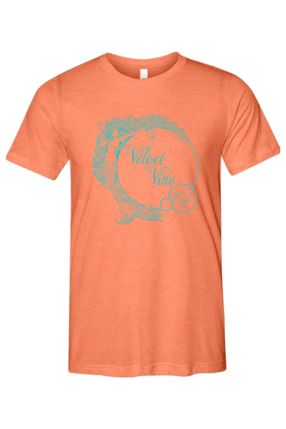 Soft orange triblend men's t-shirt featuring a teal Velvet Vine Cafe mermaid logo graphic on the chest.