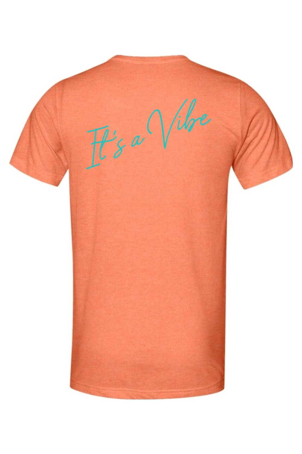 Soft orange triblend men's t-shirt featuring teal cursive "It's a Vibe" text on the back.