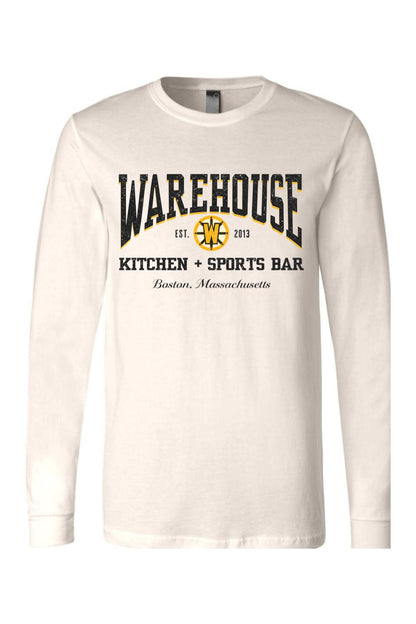 Off-white long sleeve cotton t-shirt featuring a black and gold Warehouse Kitchen + Sports Bar Boston logo.