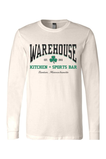 Cream-colored long sleeve cotton t-shirt with Warehouse Kitchen + Sports Bar Boston logo and green clover graphic.