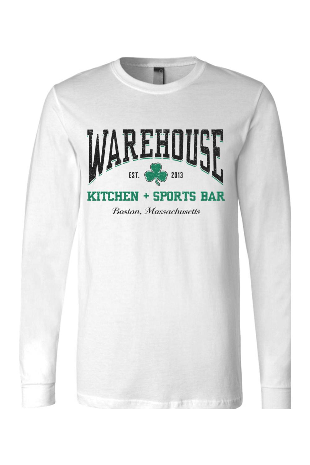White long-sleeve cotton t-shirt featuring a green Warehouse Kitchen + Sports Bar Boston clover logo graphic.