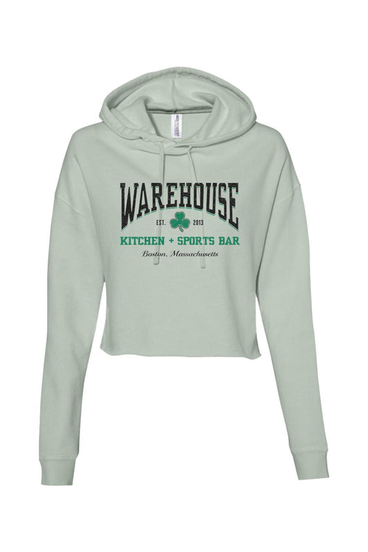 Sage green cropped hoodie with Warehouse Kitchen + Sports Bar Boston logo and clover graphic on the front.