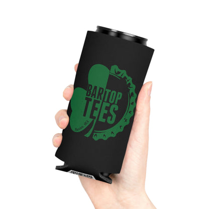 Hand holding a black slim can cooler with a green shamrock and bottle cap logo design.