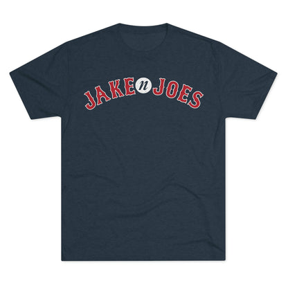 Navy blue tri-blend t-shirt featuring a red and white arched Jake n JOES baseball-style logo on the chest.