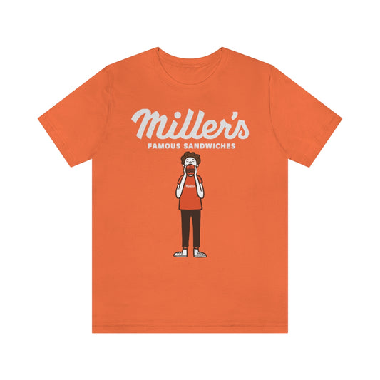 Orange short sleeve cotton tee featuring a Miller's Famous Sandwiches graphic of a person eating a burger.