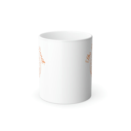 11oz white ceramic mug with The Daily Donut orange graphic, glossy finish, and C-shaped handle.