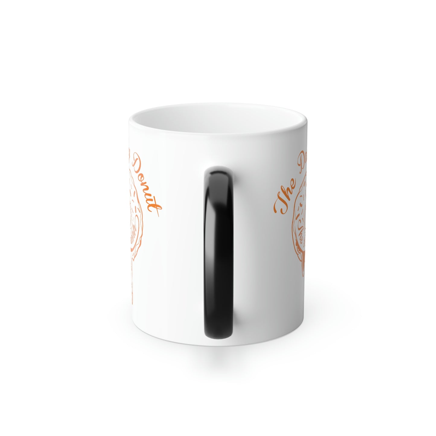 11oz white ceramic mug with a black C-shaped handle and orange The Daily Donut graphic design.