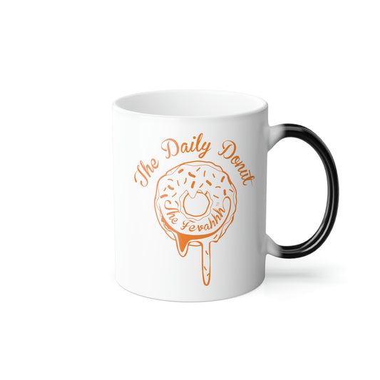 11oz ceramic heat-reactive mug with white finish, black handle, and orange The Daily Donut graphic design.