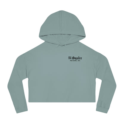 Sage green women's cropped hooded sweatshirt with The Squire Revere, MA black text logo on the chest.