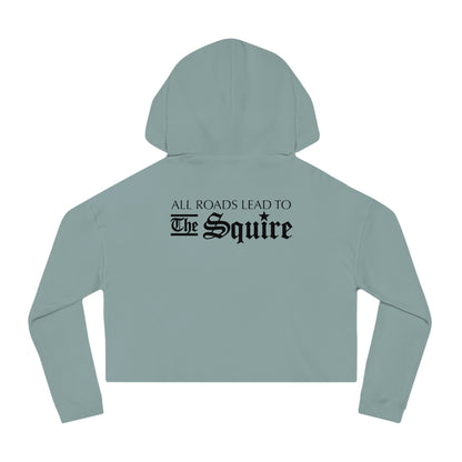 Sage green women’s cropped hooded sweatshirt featuring black text on the back that reads All Roads Lead To The Squire.
