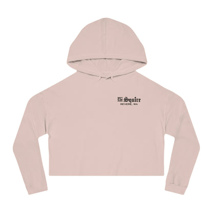 Light pink women's cropped hooded sweatshirt with The Squire Revere, MA black text logo on the chest.