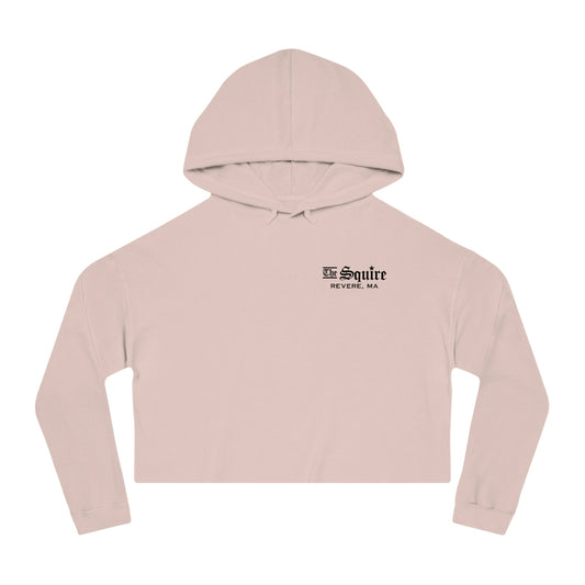 Light pink women's cropped hooded sweatshirt with The Squire Revere, MA black text logo on the chest.