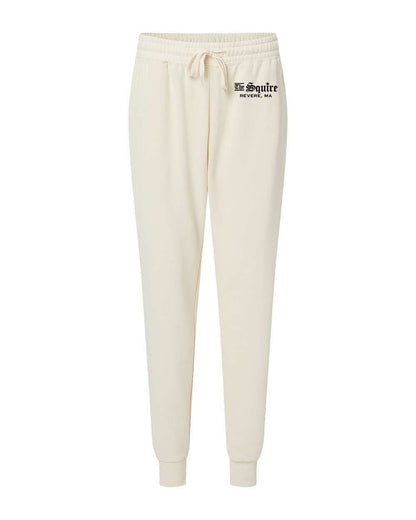 Cream-colored women's fleece sweatpants with an elastic drawstring waist, ribbed ankle cuffs, and The Squire logo.